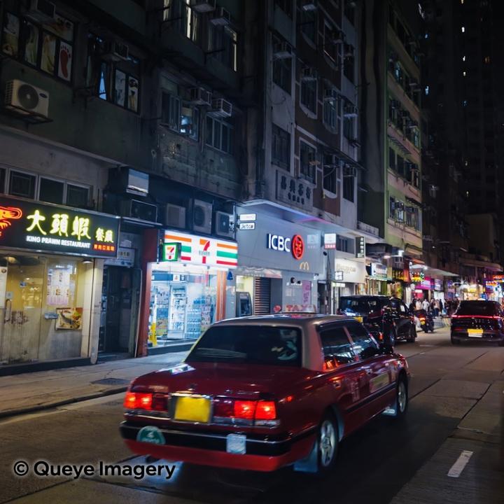 Car passing 236 Queen's Rd W at night, Sai Ying Pun, Hong Kong